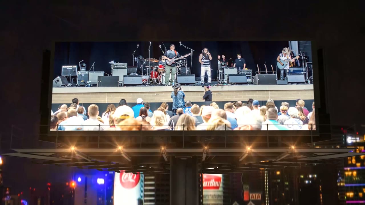 Band photos on 3D billboards over a night skyline