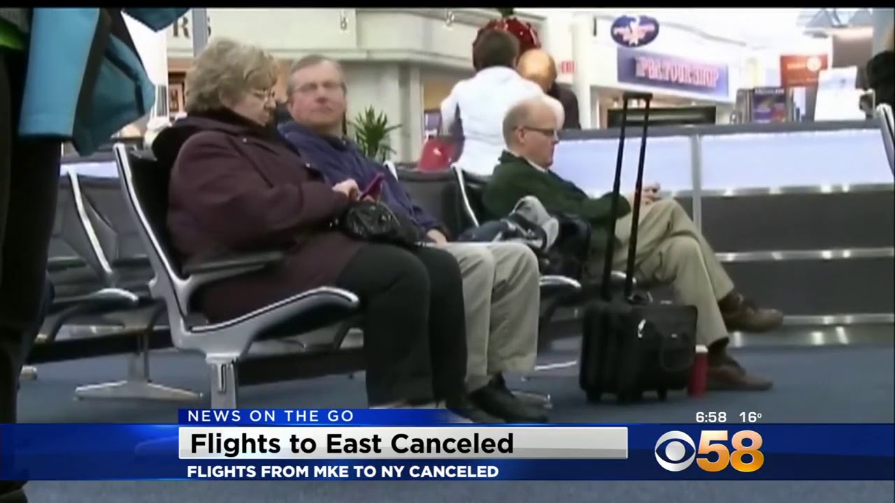 Travelers waiting at the Milwaukee airport during a CBS 58 morning newscast